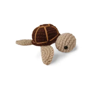 A handmade Woovy Luxury Crochet Mini Turtle with intricate stitching, featuring high-quality materials and a vibrant color palette, placed on a soft, neutral backdrop.